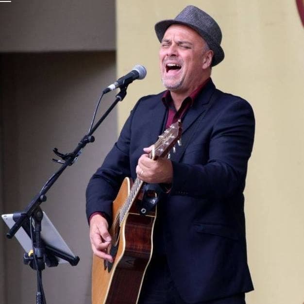 Singing in a hat at an outdoor show