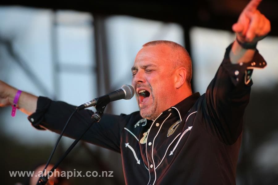 Mid-song, pointing out to the crowd